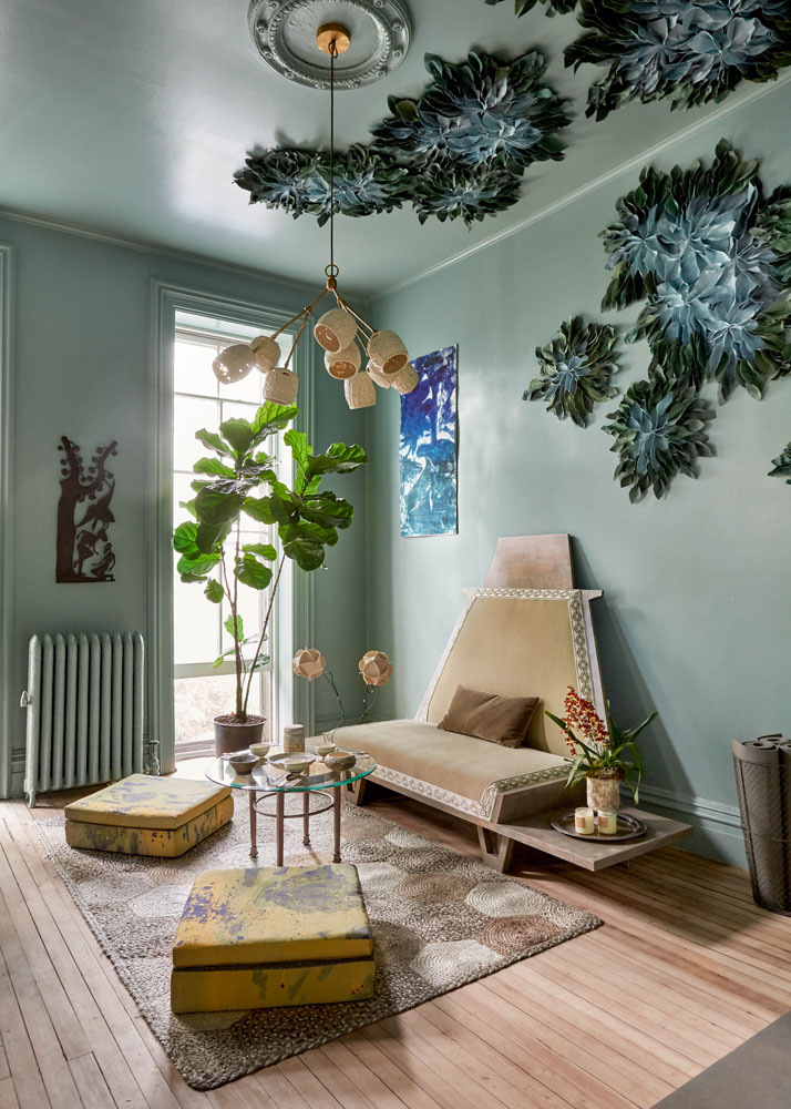 soft blue room with floor cushions and blue flower-inspired decals on the wall to the ceiling