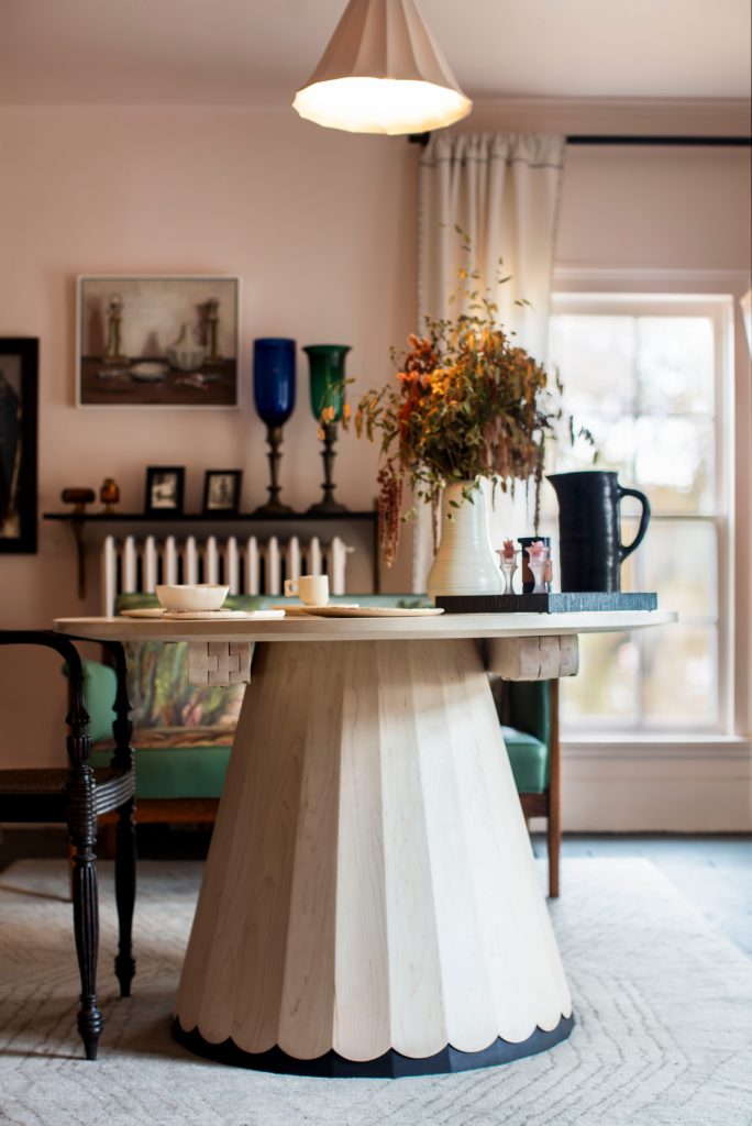 view of table with flowers on it and ceiling lamp