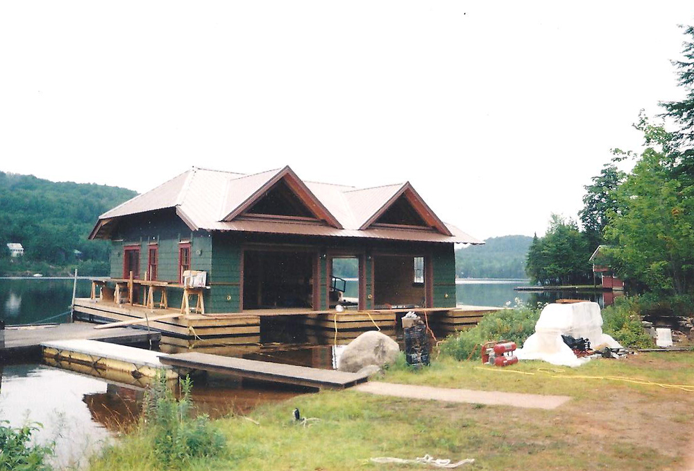 Boathouse on lake with green paint