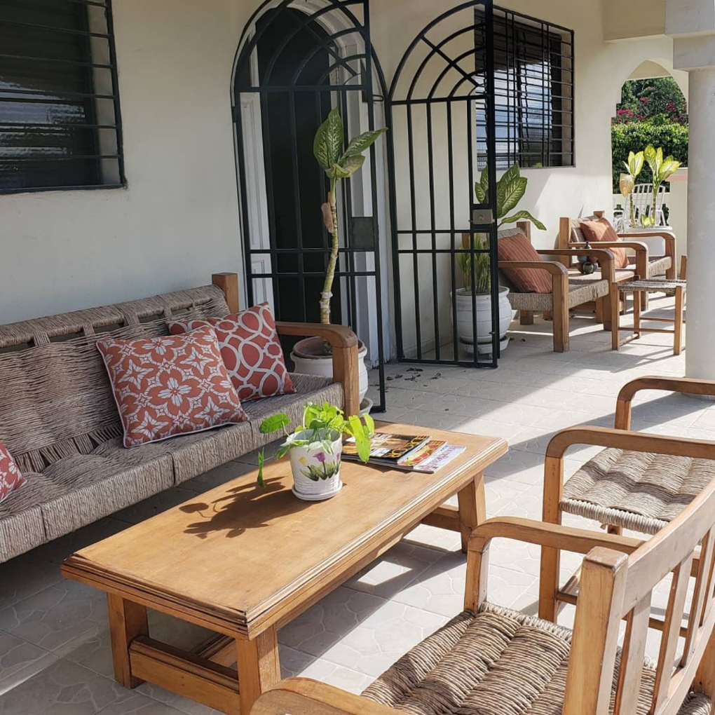 woven furniture on balcony with wooden table