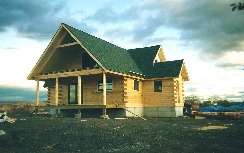 Log cabin style home with a frame roof
